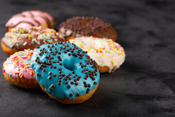 Delicious assorted colorful donuts on the table.
