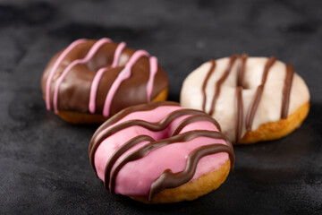 Delicious assorted colorful donuts on the table.