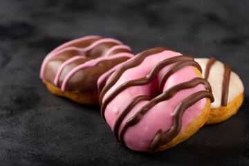 Delicious assorted colorful donuts on the table.