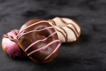 Delicious assorted colorful donuts on the table.