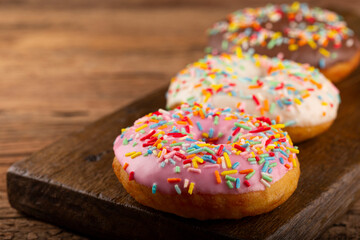 Delicious assorted colorful donuts on the table.