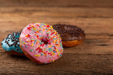 Delicious assorted colorful donuts on the table.