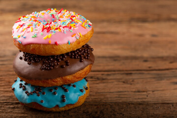 Delicious assorted colorful donuts on the table.