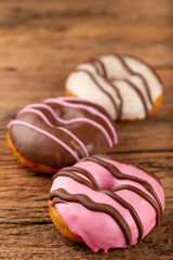 Delicious assorted colorful donuts on the table.