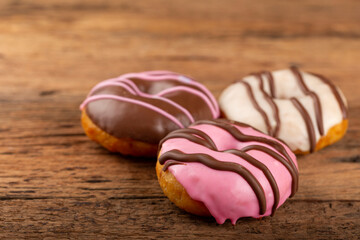 Delicious assorted colorful donuts on the table.