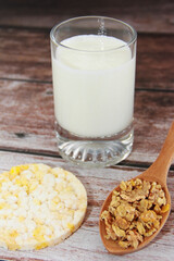 kefir in a glass and muesli in a spoon for a diet