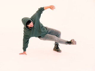 Portrait of handsome Asian hip hop dancer dancing in the studio, isolated on white background.