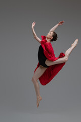 Professional ballet dancer with red silk inside studio