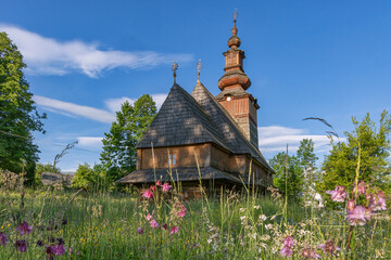 Fototapeta na wymiar Old wooden church against blue sky, historic architecture, religion background