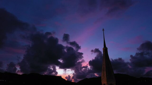 .colorful cloud above pagoda of Chalong pagoda in twilight..beautiful architecture pagoda of Chalong temple in the night..4k colorful cloud scape sky sunset.
