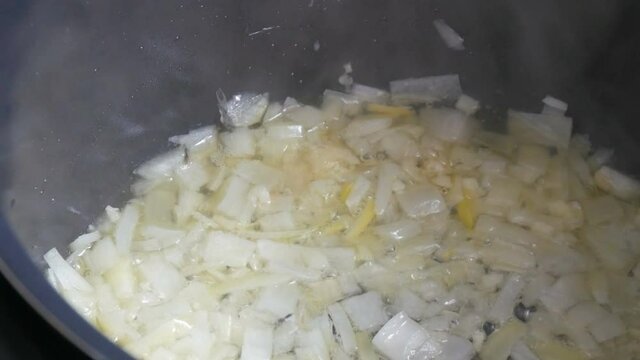 Sliced onion fried in sunflower oil close up