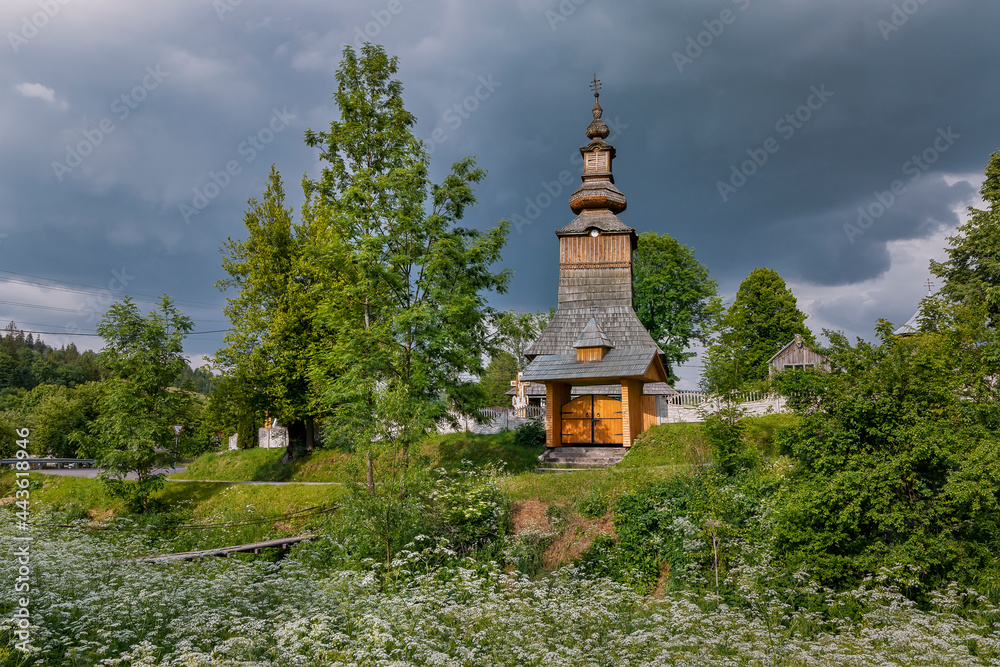 Wall mural Old wooden church against dramatic sky, historic architecture, religion background