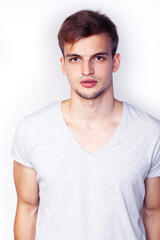 young handsome teenage hipster guy posing emotional, happy smiling against white background isolated, lifestyle people concept