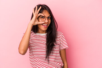 Young latin woman isolated on pink background excited keeping ok gesture on eye.