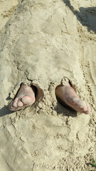 Happy child boy sunbathes on the beach in summer.
