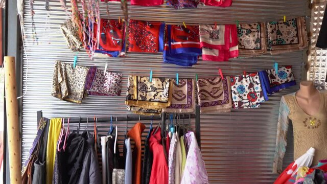 Many colorful different souvenirs and clothes selling for tourists outdoors on small market