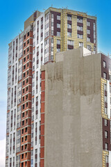 Exterior of a residential building under construction on a summer day