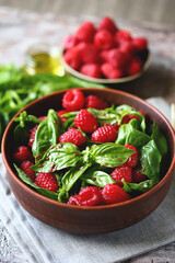 Healthy summer raspberry salad with basil in a bowl. Vegan food. Fitness lunch.