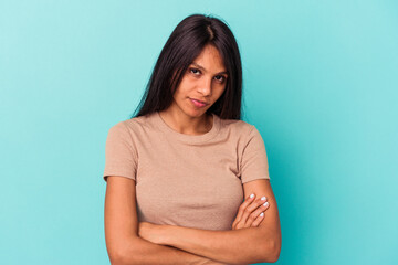 Obraz premium Young latin woman isolated on blue background who is bored, fatigued and need a relax day.
