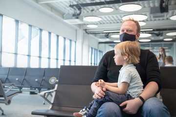 Family father with a child at the airport waiting for their departure