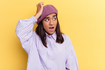 Young mixed race woman isolated on yellow background being shocked, she has remembered important meeting.