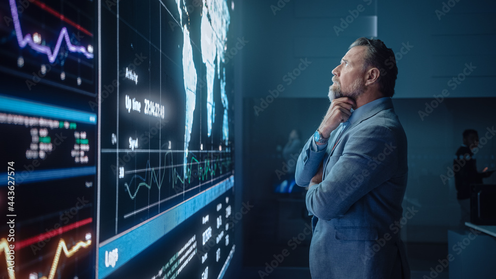 Poster Senior Computer Science Engineer Looking at Big Screen Display Showing Global Map with Data Points. Telecommunications Technology Company System Control and Monitoring Room with Servers.