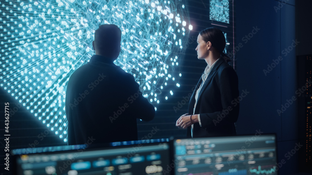 Fototapete Project Manager and Computer Science Engineer Talking while Using Big Screen Display Showing Neural Connections and Data. Telecommunications Company System Control and Monitoring Room.