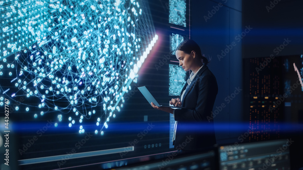 Leinwandbilder Young Female Computer Science Engineer Working on Laptop next at Big Screen Display Showing Neural Data. Telecommunications Technology Company System Control and Monitoring Room with Servers.