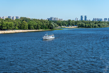 Obraz premium Tourists boat on its way to Podol district on Dnypro river in Kyiv, Ukraine on August 30, 2020. 