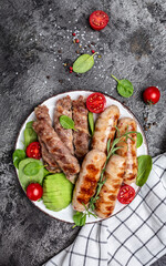 Grilled Munich Veal Sausages and meat rolls wrapped bacon, chevapchichi or Kofta kebab. Ketogenic diet, vertical image. top view. place for text