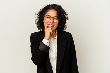 Young latin business woman isolated on white background biting fingernails, nervous and very anxious.