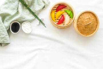Asian steamed dumplings in wooden steamer. Traditional Chinese dim sum set