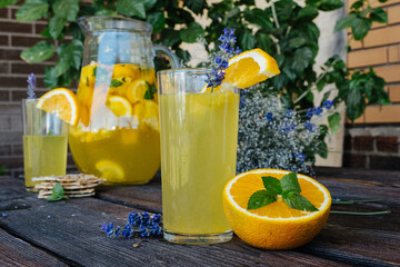 cold drink summer lemonade of oranges and mint with lavender