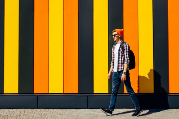 Full length, photo of positive carefree joyful optimistic guy walking somewhere on isolated colorful bright background