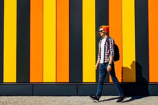 Full length, photo of positive carefree joyful optimistic guy walking somewhere on isolated colorful bright background