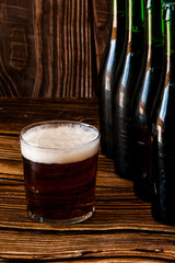 Un corto de cerveza con unas botellas 