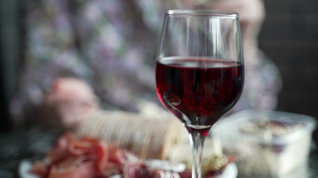 Red wine in the glass and snacks.