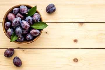 Purple plums in bowl. Plum harvest top view