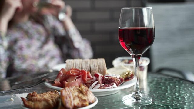 Red wine in the glass and snacks.
