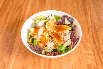 Sprout salad bowl with apple slices, white onion, canned tuna torozos and parmesan cheese flakes