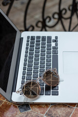 personal computer and sunglasses for working online in summer holidays