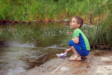 Boy with a boat. Photo taken with selective focus.
