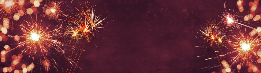 Silvester New Year background banner panorama long- firework, sparklers and bokeh lights, on pink...