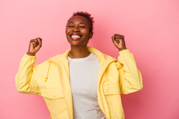 Young african american woman isolated on pink background celebrating a victory, passion and enthusiasm, happy expression.