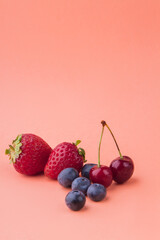 Vertical shot of fresh ripe fruits isolated on orange background.
