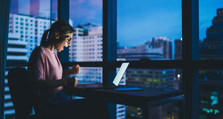 Fototapeta premium Happy shouting woman looking at laptop working on project