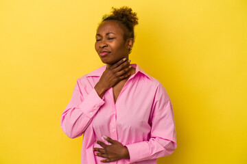 Obraz na płótnie Canvas Young african american woman isolated on yellow background suffers pain in throat due a virus or infection.