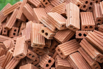 selective focus orange brick blocks piled on the floor orange bricks used to build houses and buildings used to build walls