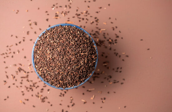 Peganum harmala seeds in a bowl, top view. Copy space. Peganum harmala is also called -Syrian rue- and contains harmala alkaloids such as harmine, harmaline and tetaphydroharmine.