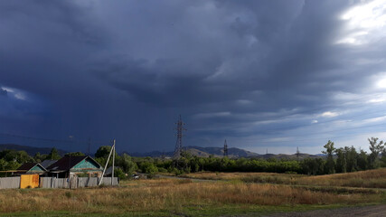 a dark thundercloud over a small town